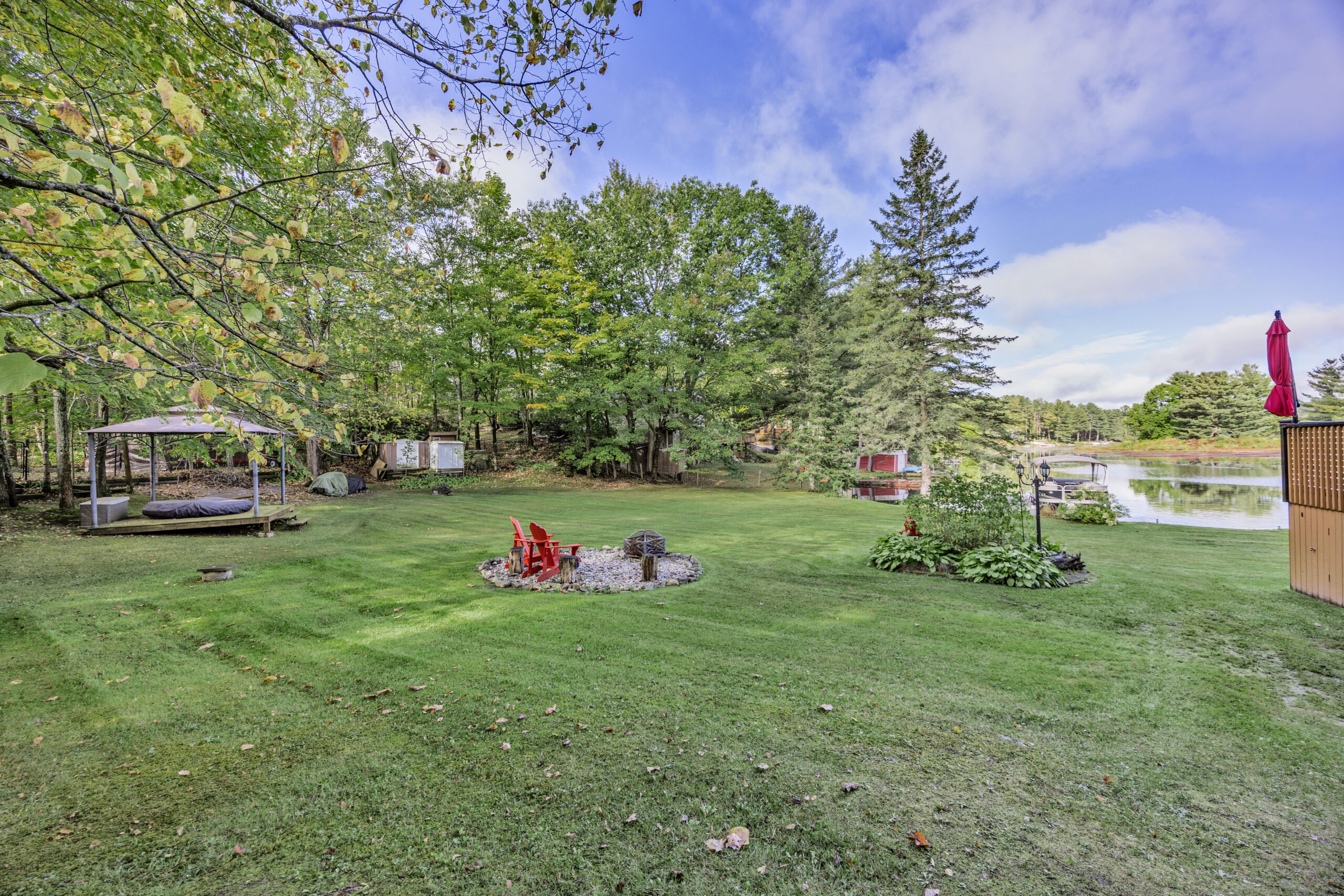 A small fire pit on a large grassy yard