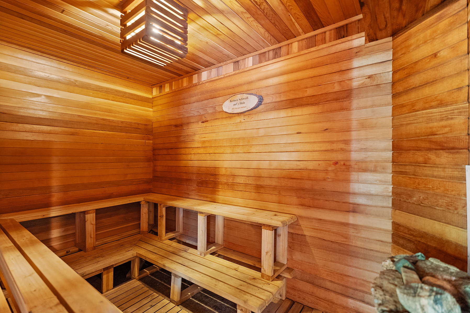 A wood paneled sauna with benches