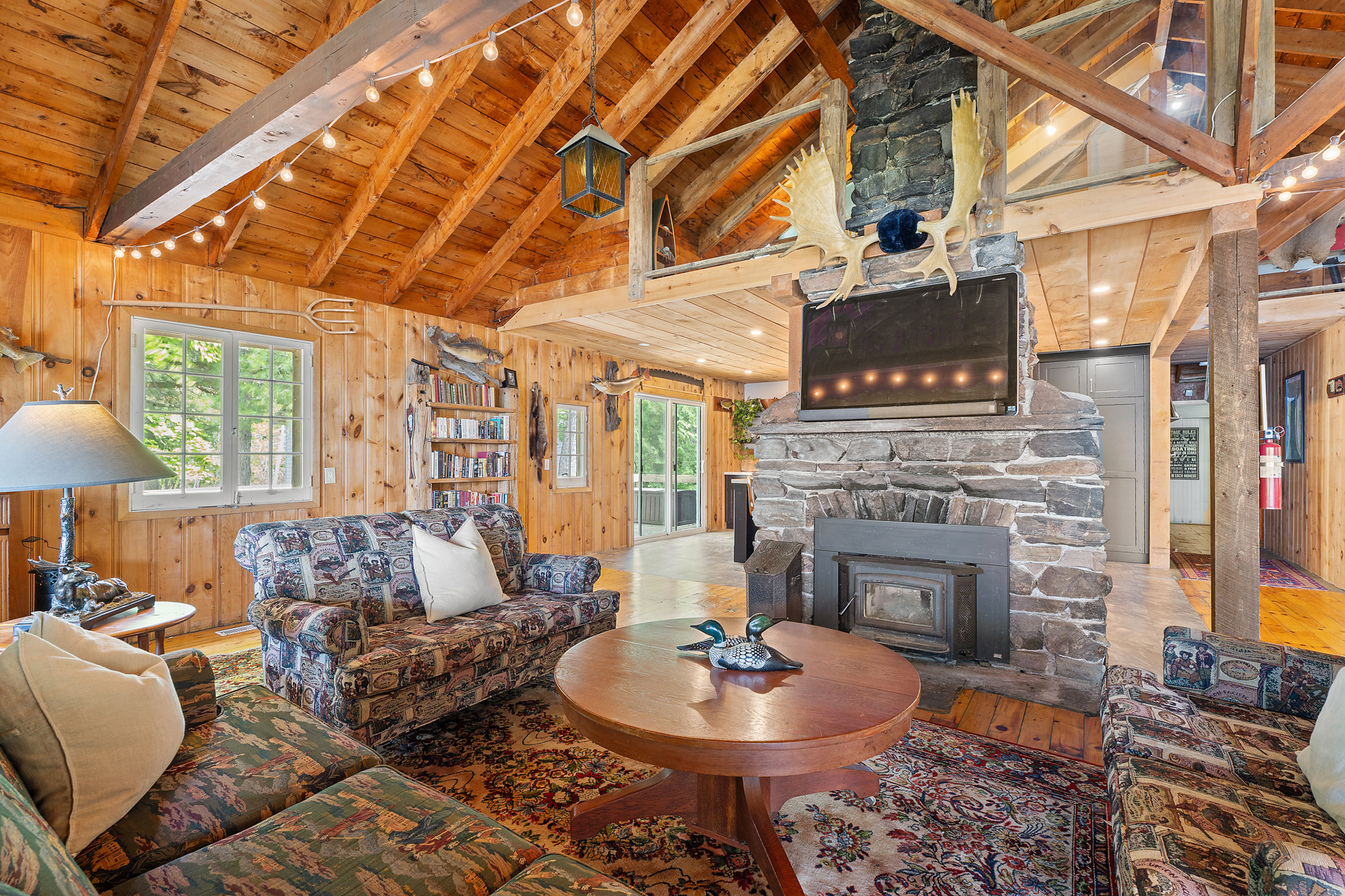 Patterned couches surround a round wood table