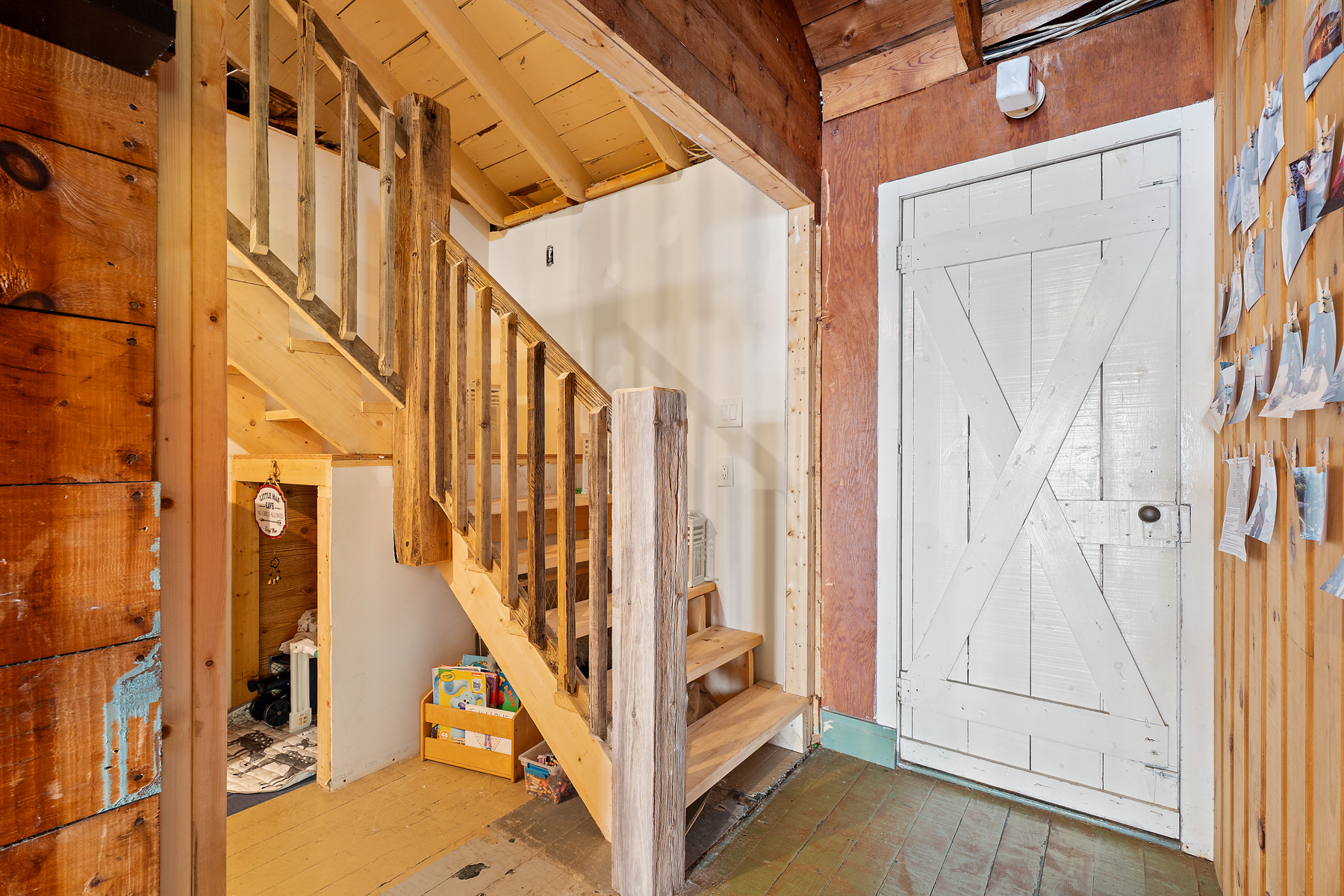 Wood stairs next to a white wall