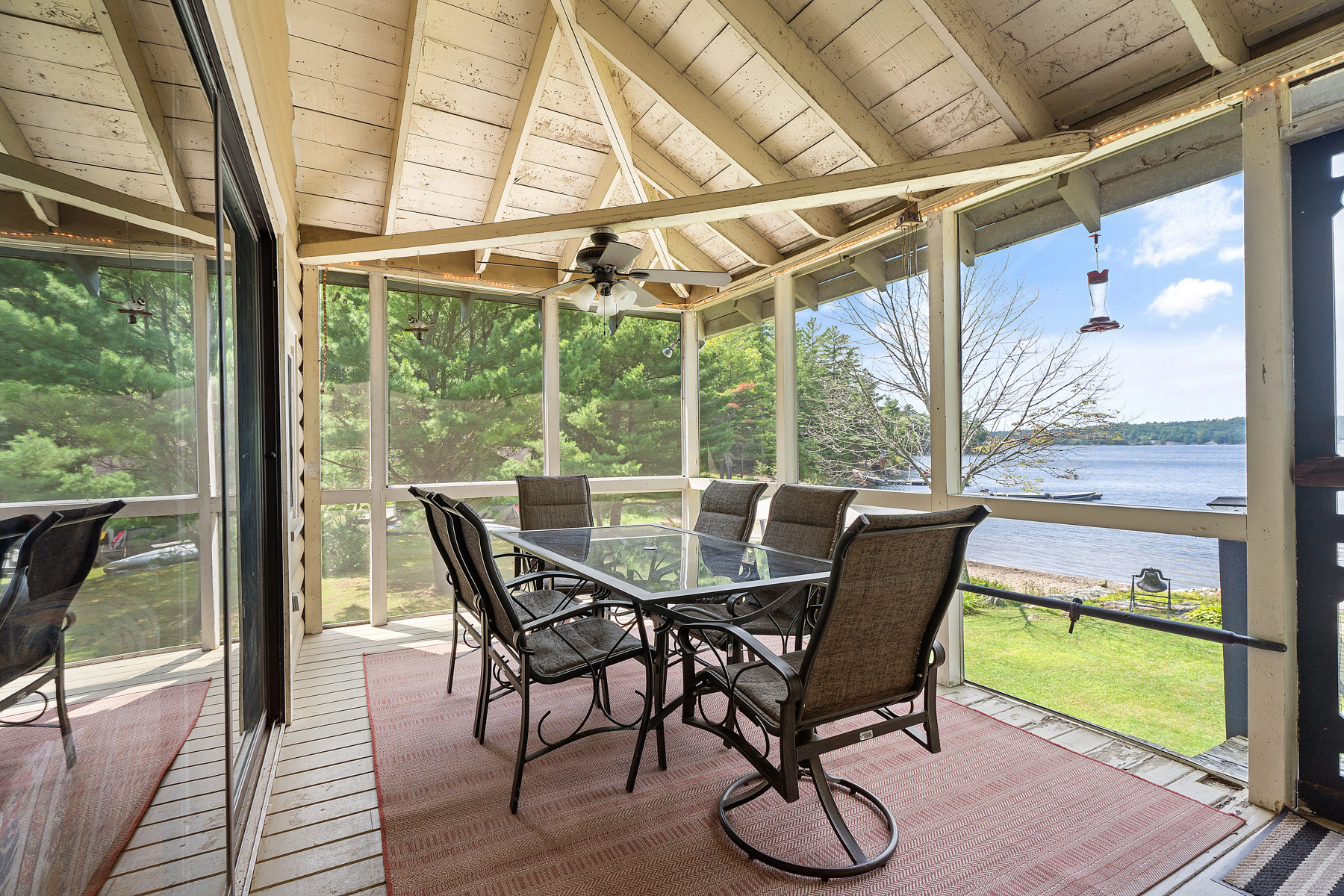 A dining table in a screened-in porch