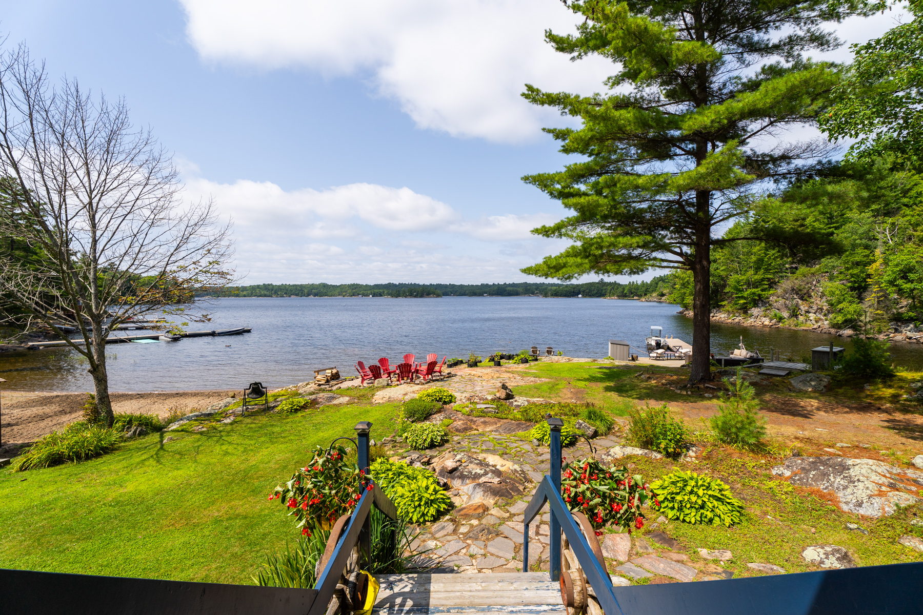 Steps lead down to a garden and a huge green lawn