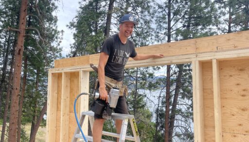 Contractor Todd Talbot stands beside a fence