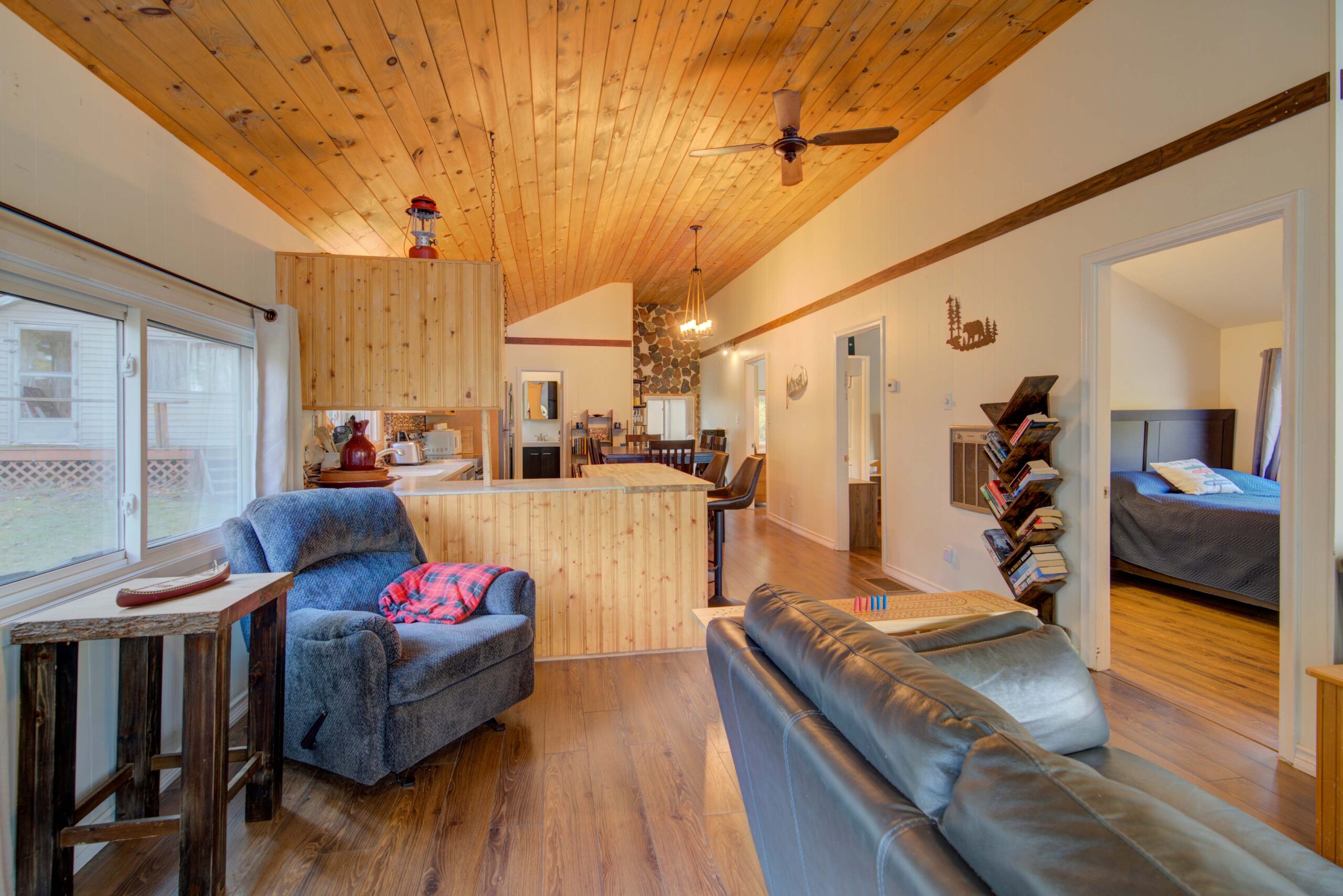 A small grey chair in the corner of a grey room