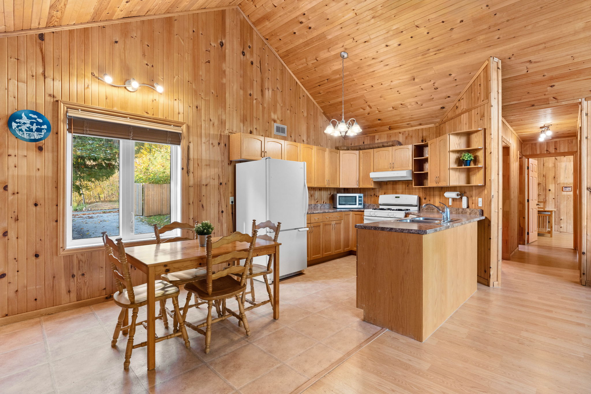 An open-concept kitchen and dining area with vaulted ceilings