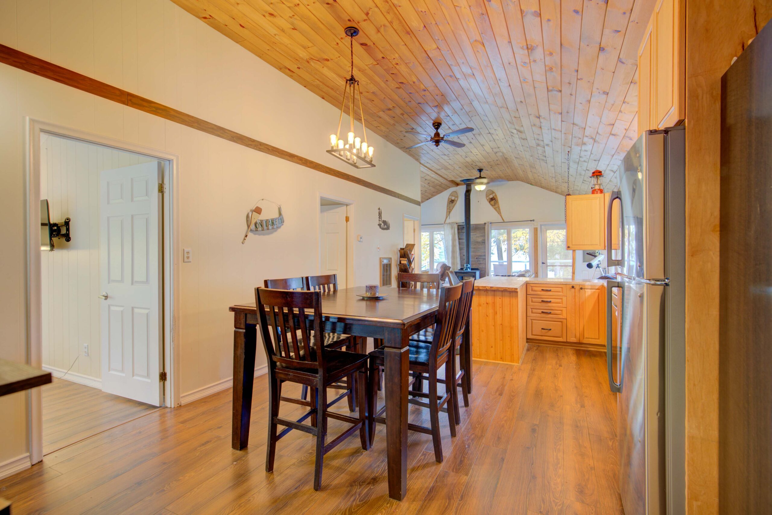 A small wood dining table and chairs in a wood room