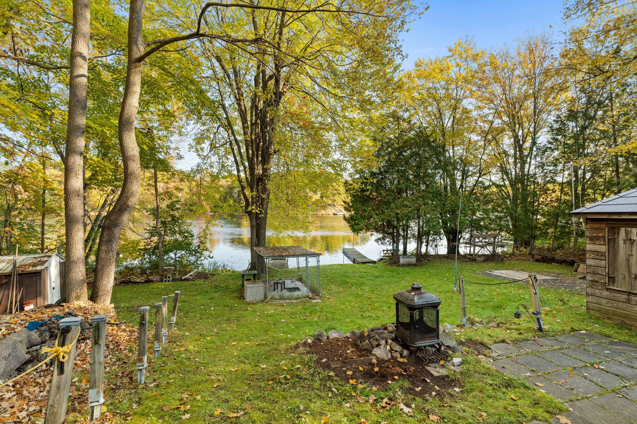 A small fire pit in a grassy area near the lake
