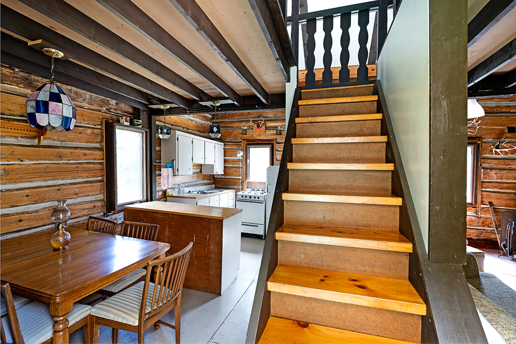 Wood steps lead upstairs in a cabin