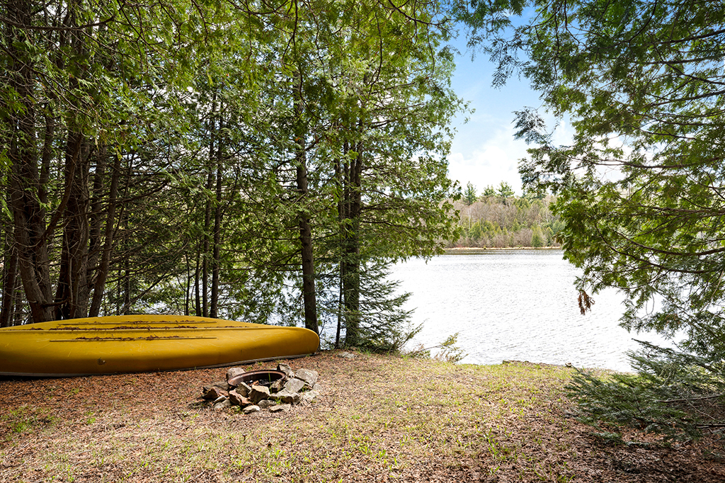 A small yellow boat on the shores of a lake