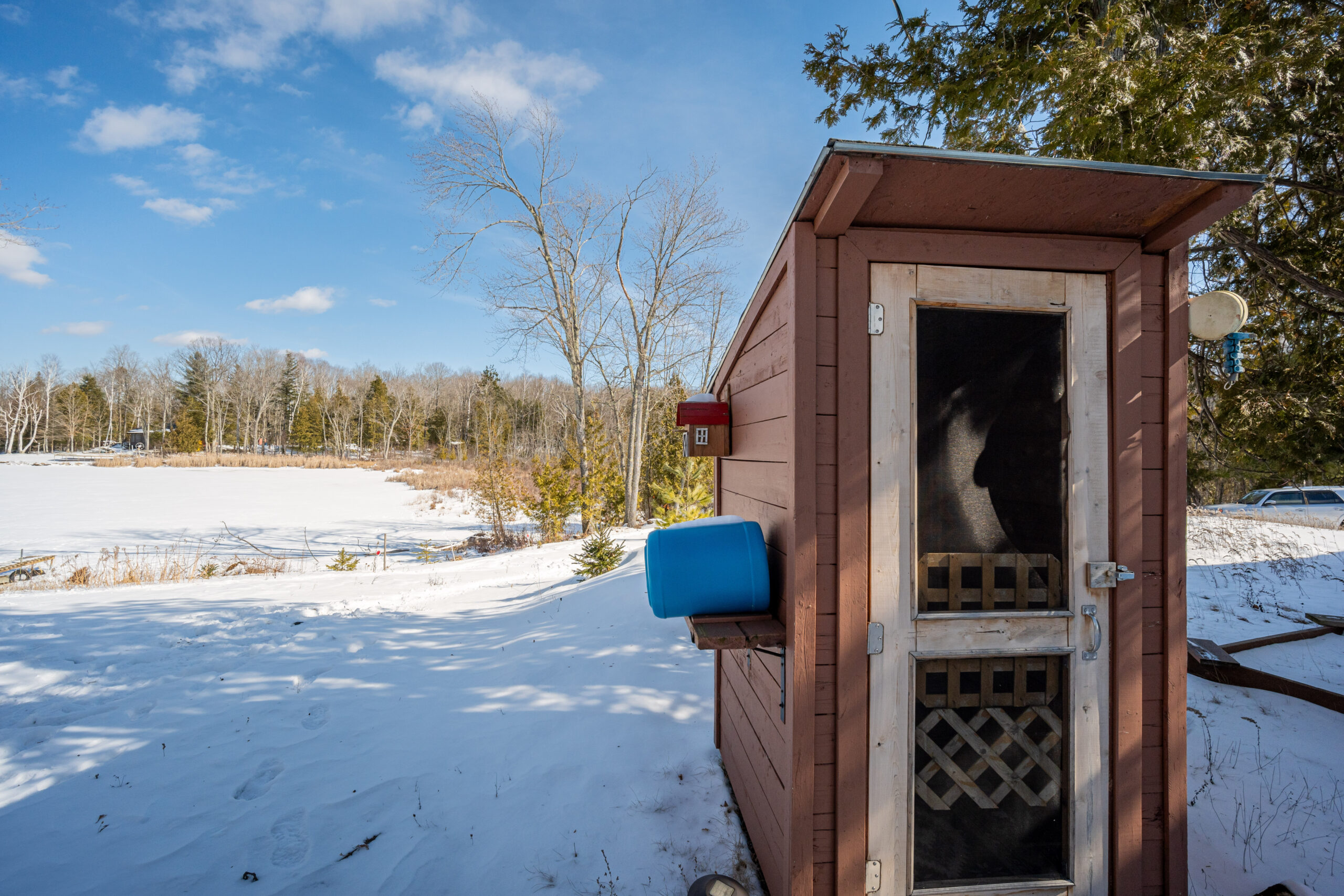 A small outhouse in the snow