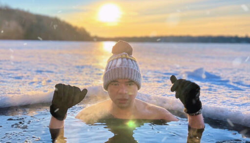 A man partially submerged in an icy lake