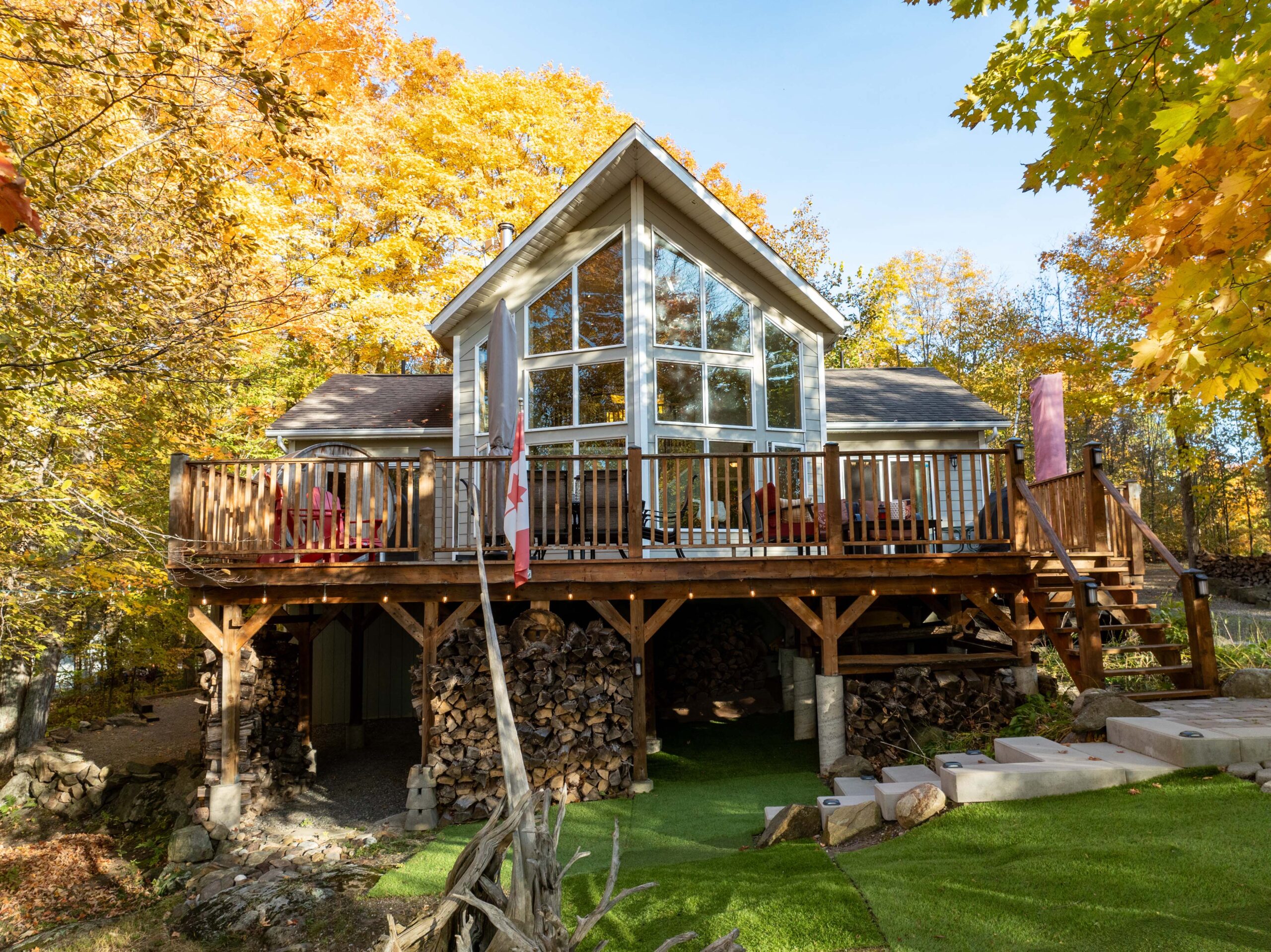 A viceroy-style cottage with huge windows and a large deck on stilts