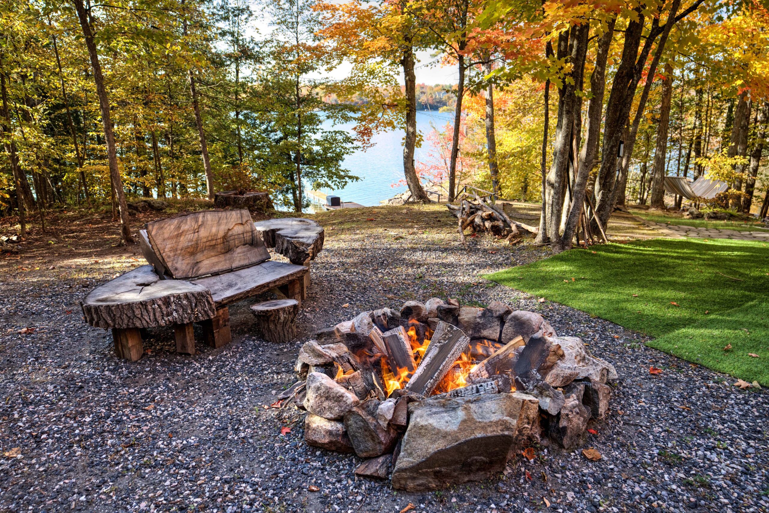 A fire pit area with the lake in the background