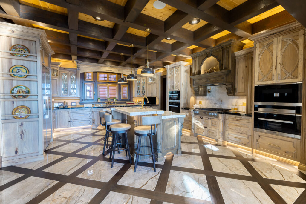 a kitchen with an island that has chairs around it