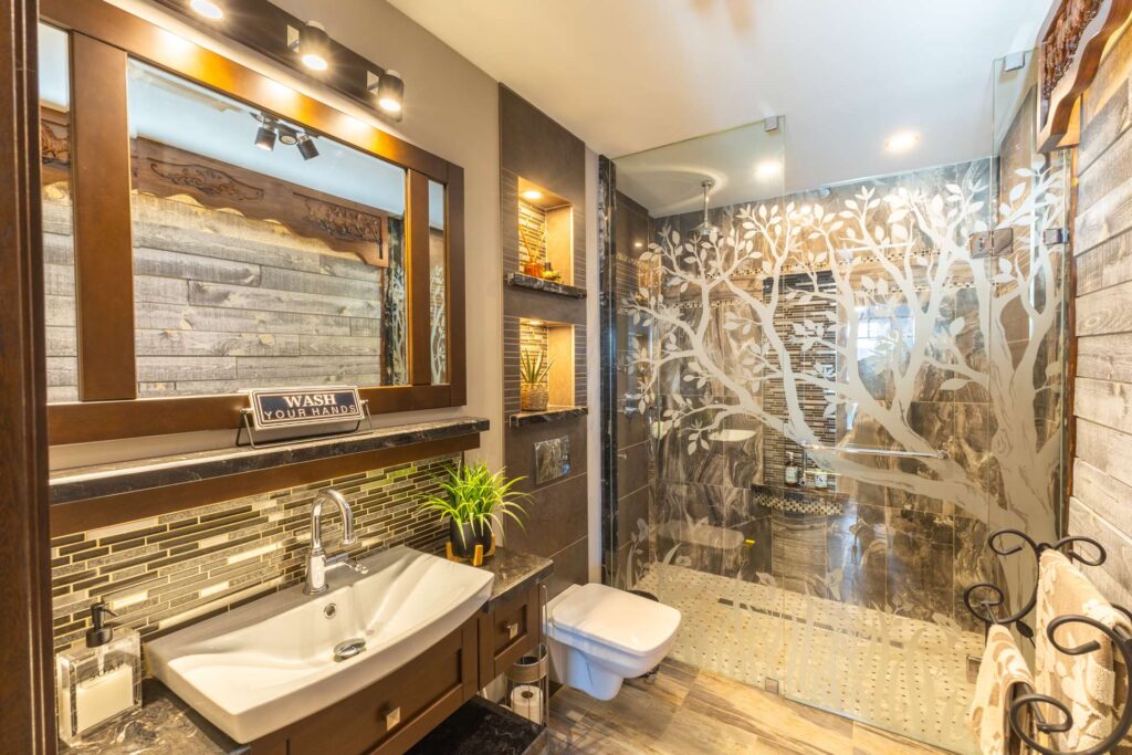 A brown and black bathroom with a glass shower
