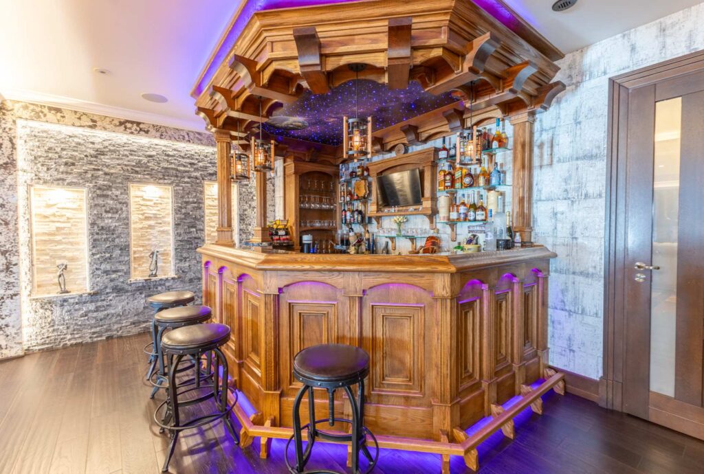 An ornate wood bars with purple lighting