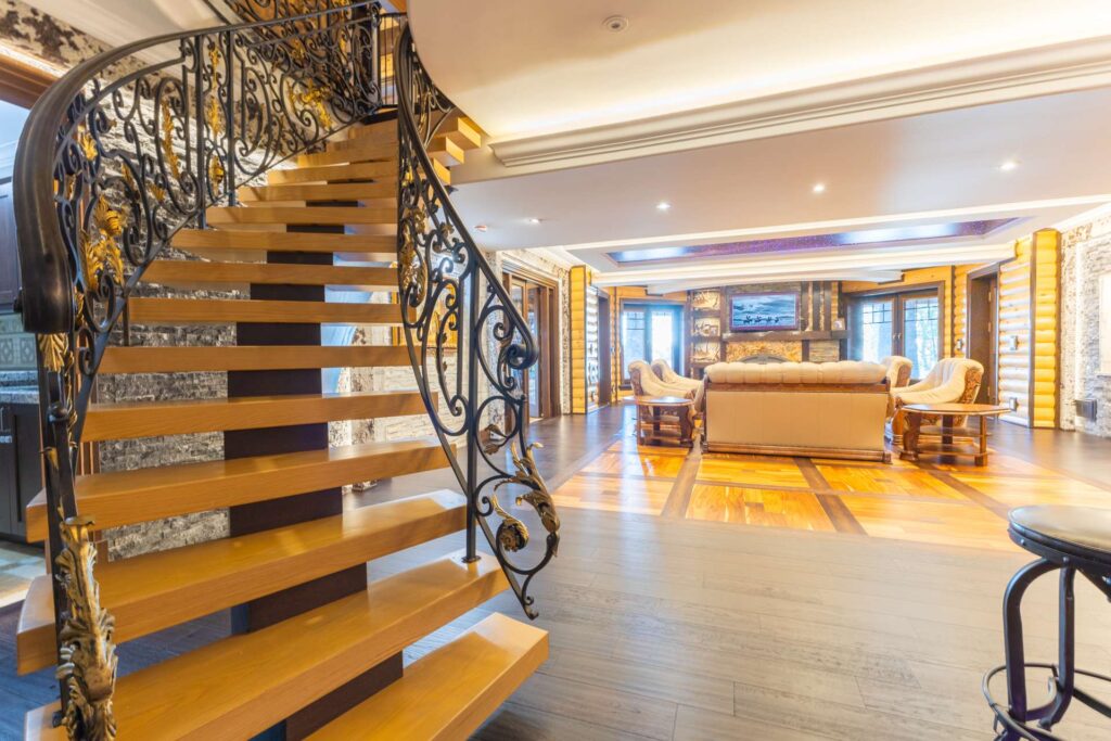 A wood spiral staircase leads down to a basement