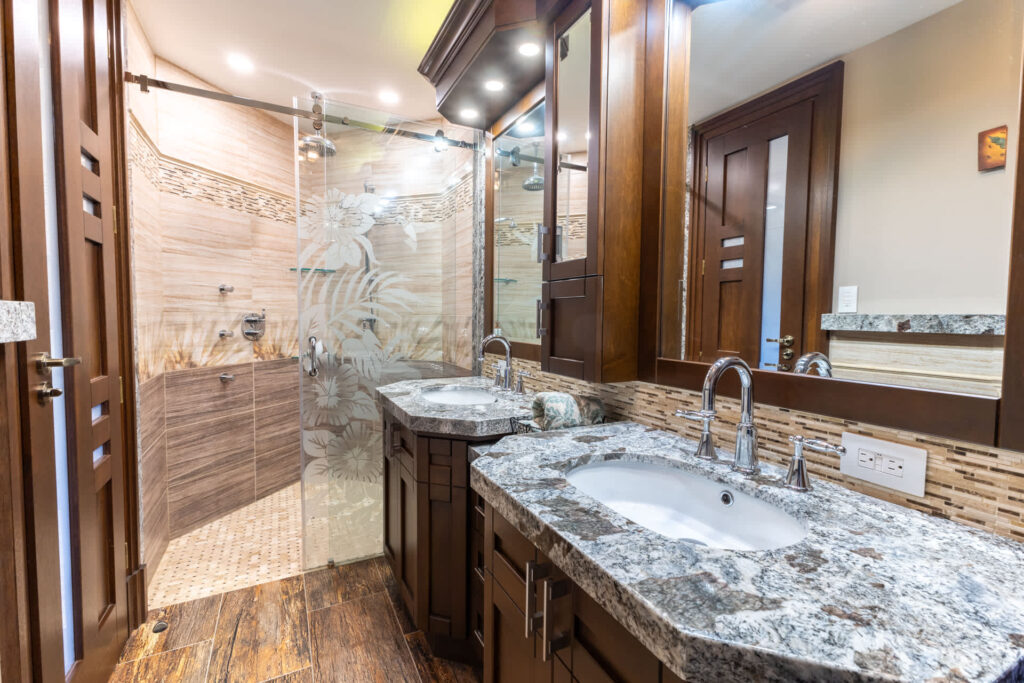 A glass shower and double marble sink
