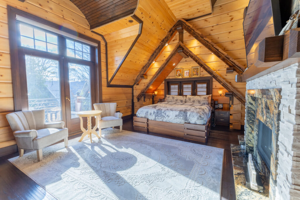 A white bed faces a large white carpet