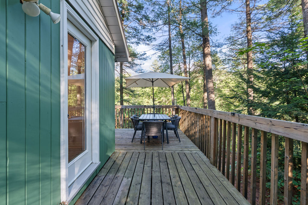 An outdoor dining set at the corner of the deck