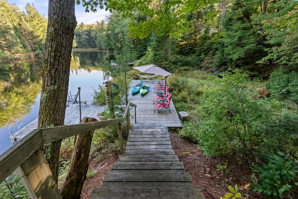 Wooden steps lead down to a spacious dock