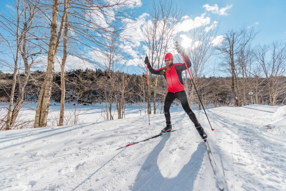 A man skiing using skate ski technique