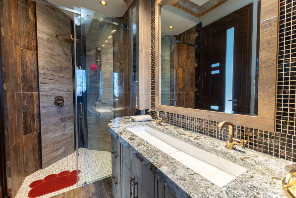 A glass shower next to a rectangular sink