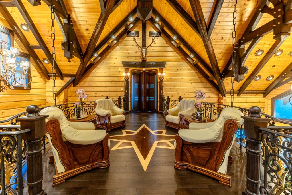 Wood chairs with white cushions face each other