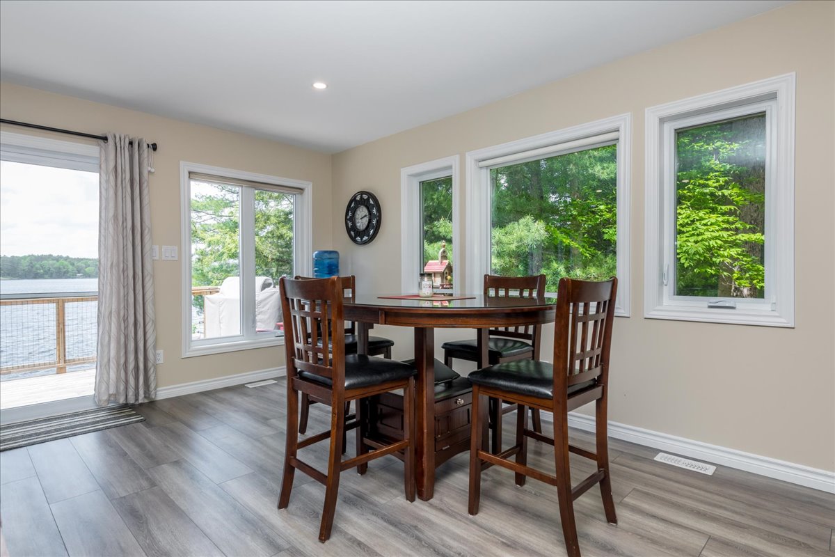 A dark brown high-top dining table in the corner of the beige room
