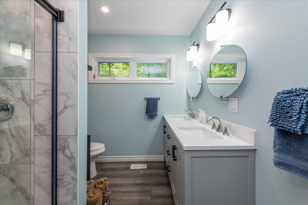 A grey bathroom with grey hardwood floors