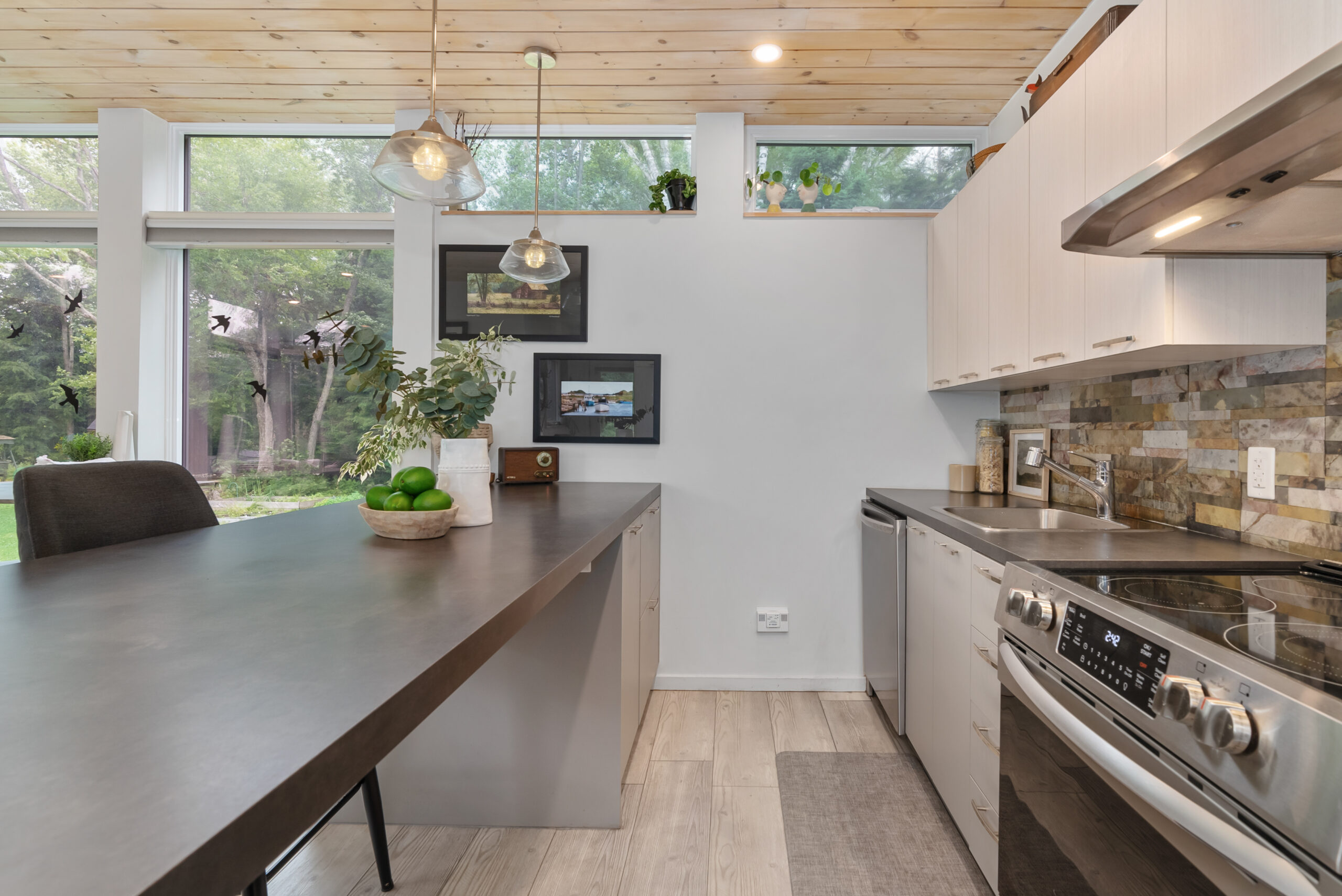A grey kitchen island faces a stove