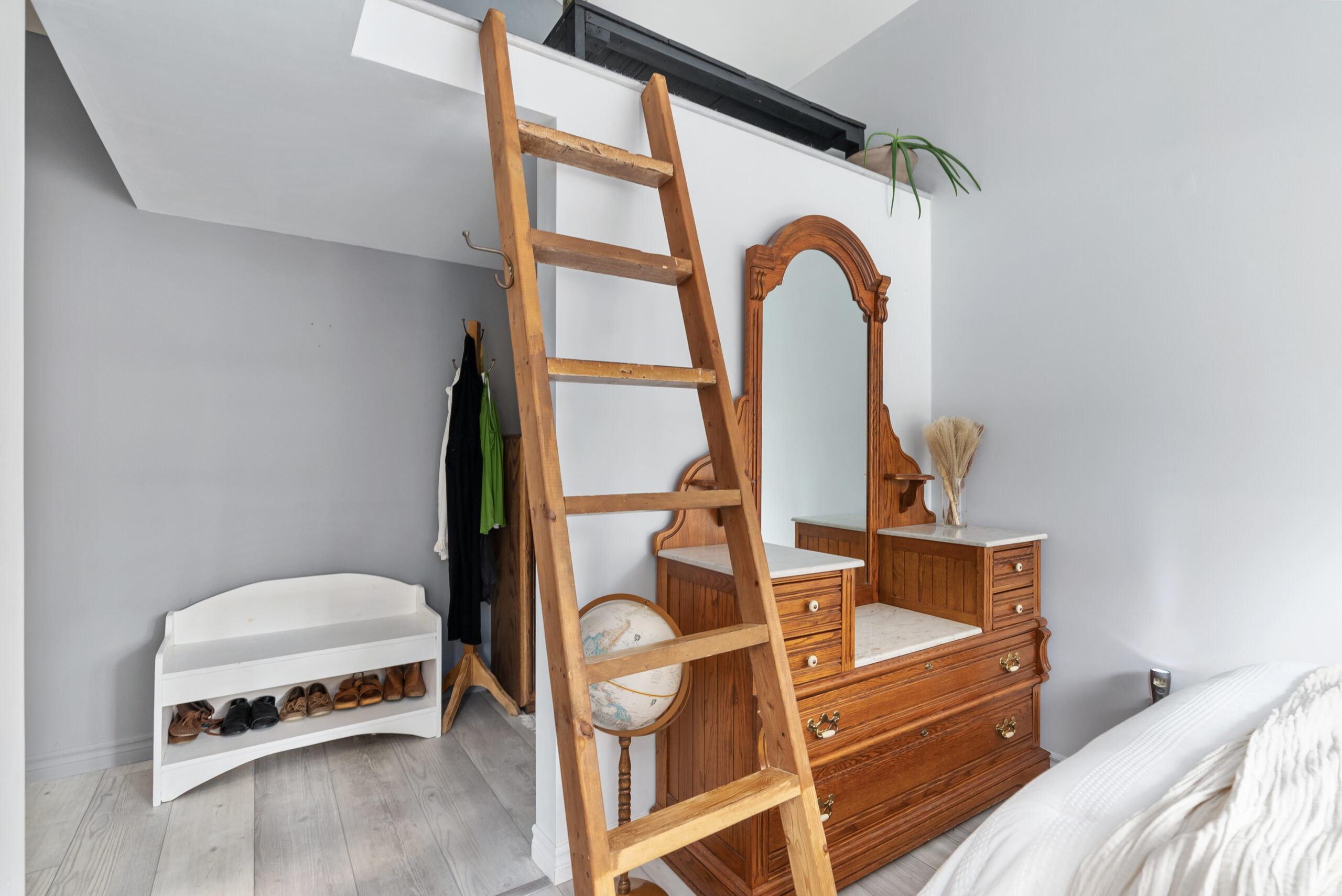 a wooden wardrobe and a ladder in a bedroom