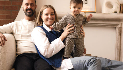 a young family smiles for a photo