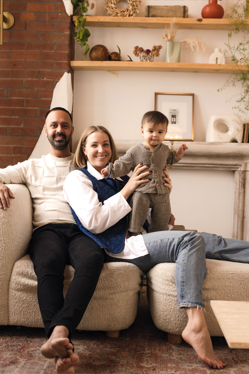 a young family smiles for a photo