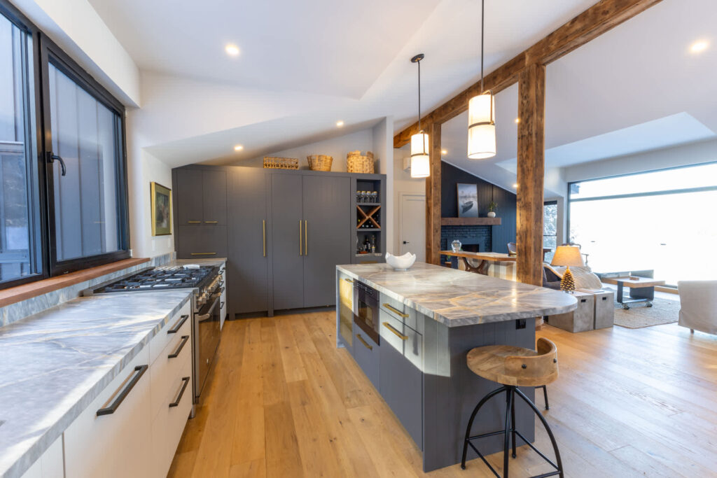 A grey kitchen with a huge grey marbled island