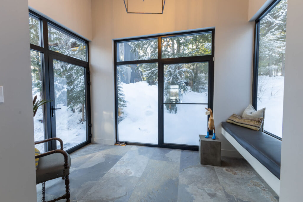 A huge glass door opens into a spacious entryway
