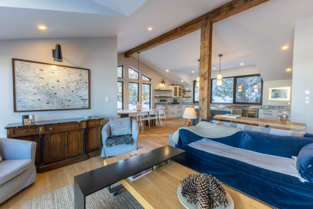 A blue couch faces a wood coffee table