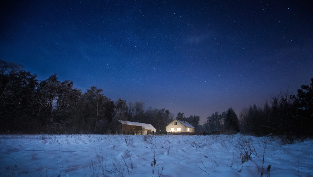 Winter night landscape with house near forest. Calm night in the countryside