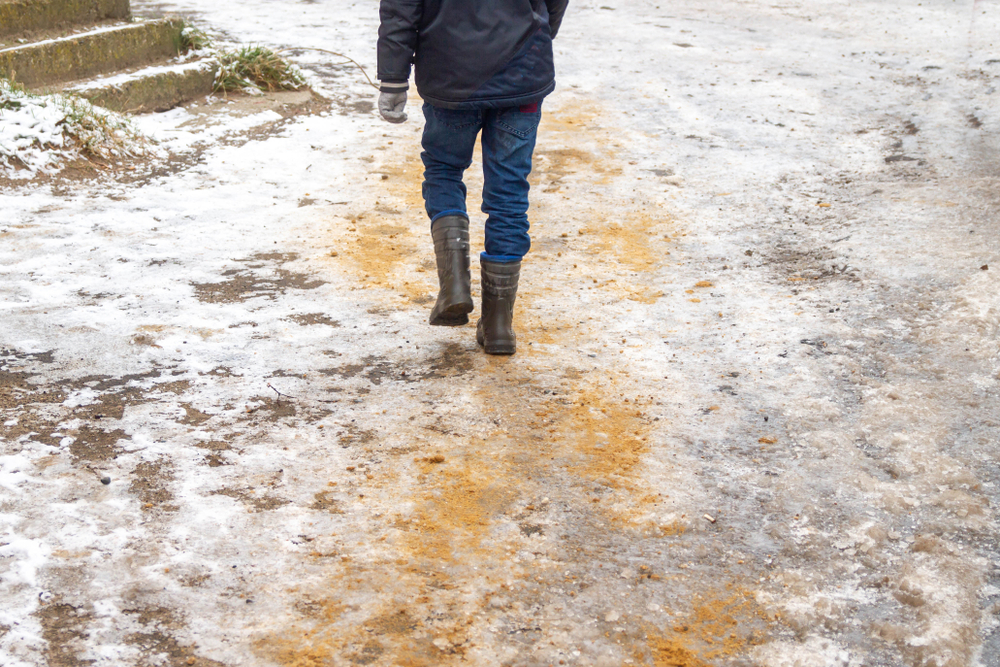 Shot of a man sanding the icy ground