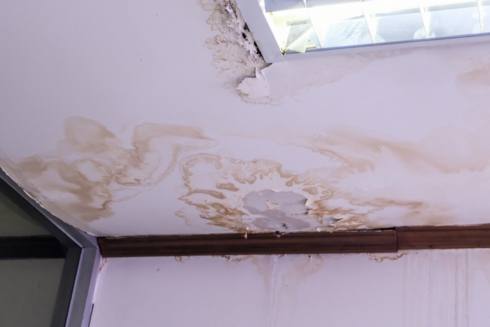 A ceiling with signs of water damage
