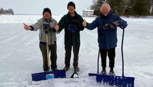 The three rink makers standing on the ice with their shovels