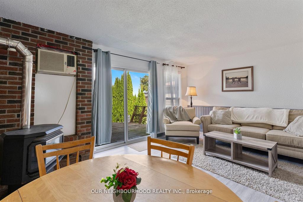 A wood table faces a small living area with sliding glass doors
