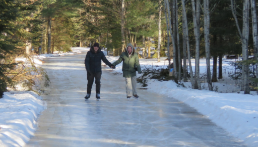 A couple skating on a trail