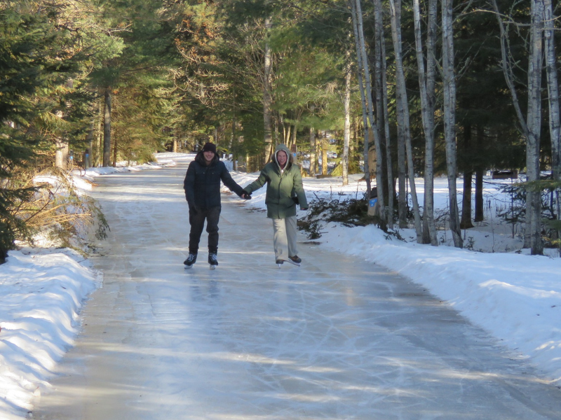 A couple skating on a trail