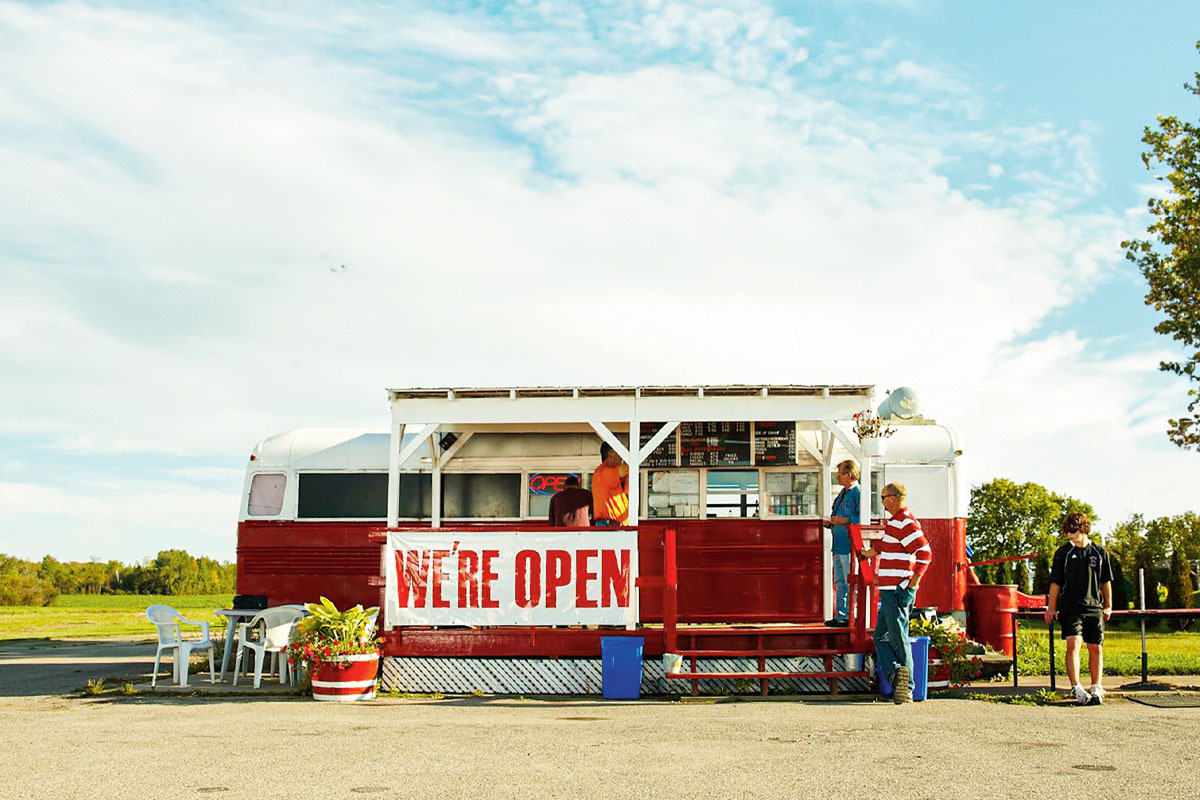 a photo of a chip truck against a blue sky with white clouds