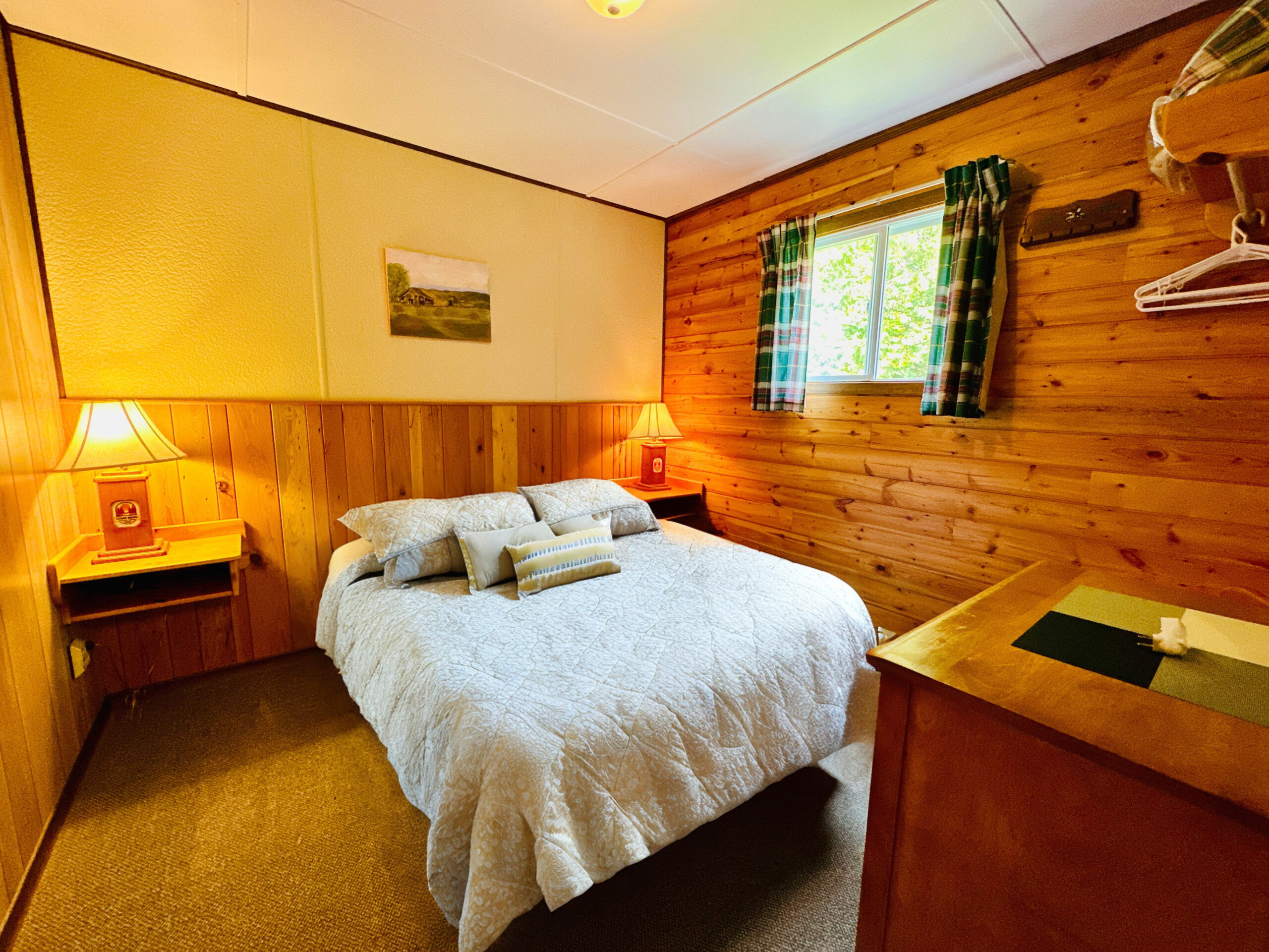 A cozy bedroom inside one of the resort’s cabins, featuring a warm wooden interior and comfortable bed.