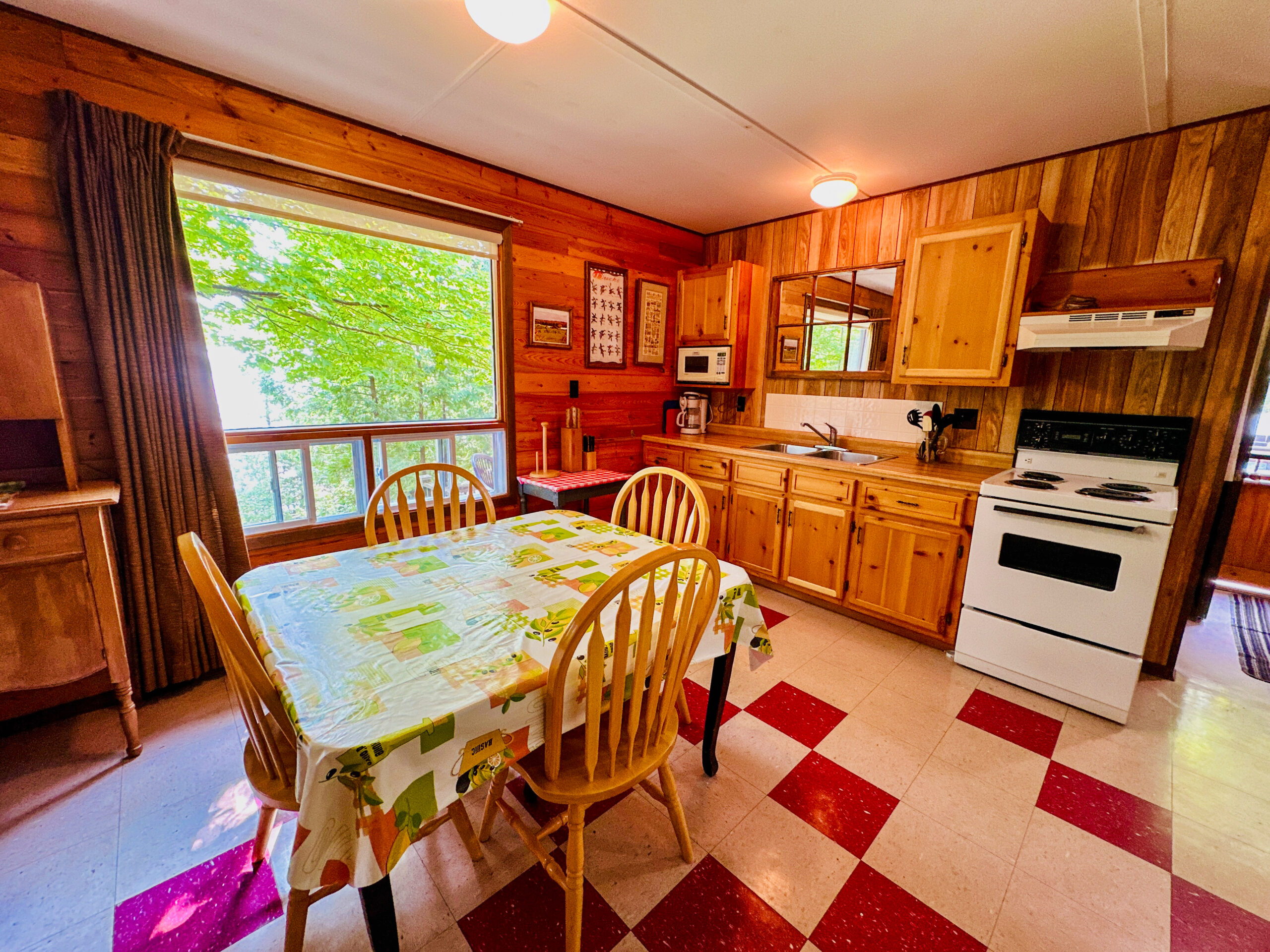 A fully equipped cabin kitchen featuring wooden cabinetry, modern appliances, and ample counter space.