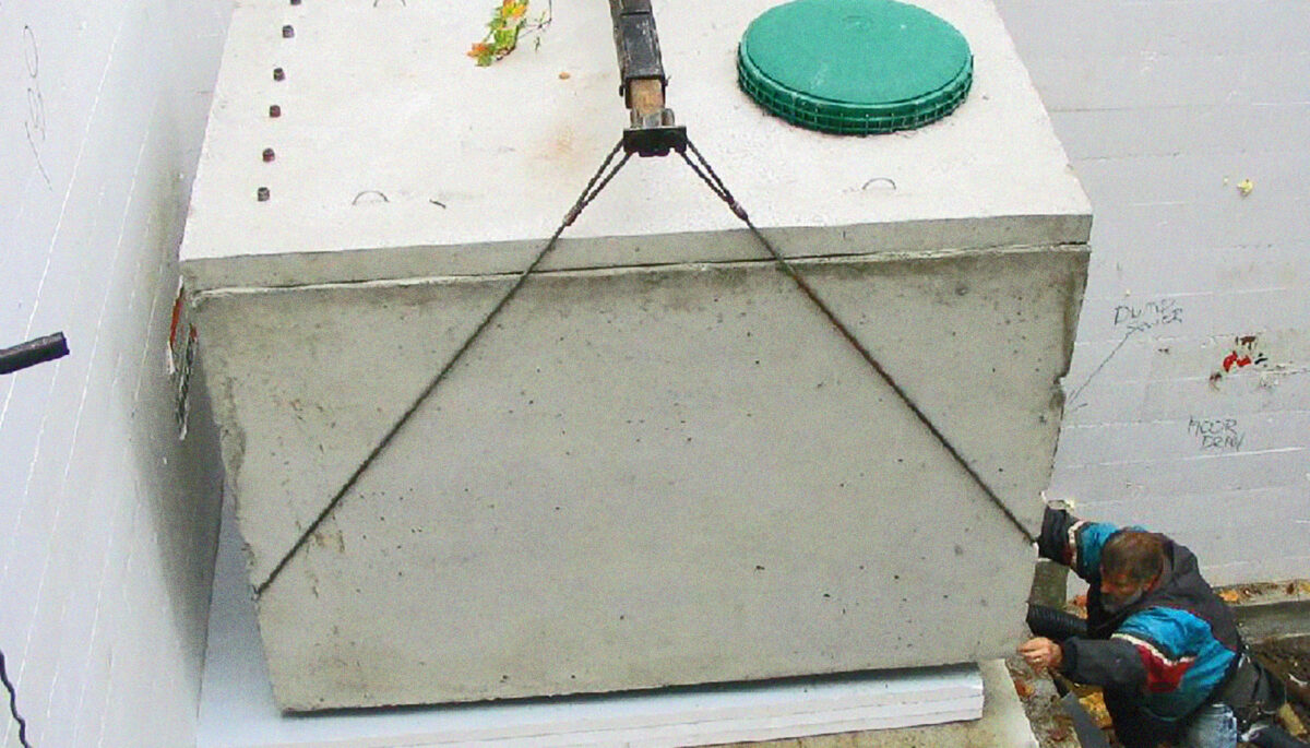 A large water tank held by a hoisting lift