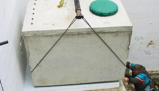 A large water tank held by a hoisting lift