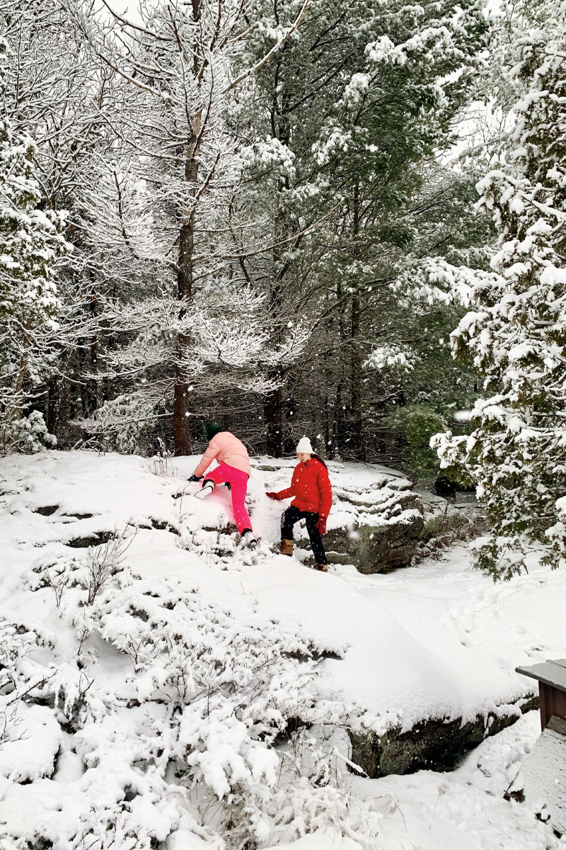 Writer Sasha Chapman's daughters traverse a snowy rockface during a winter cottage visit